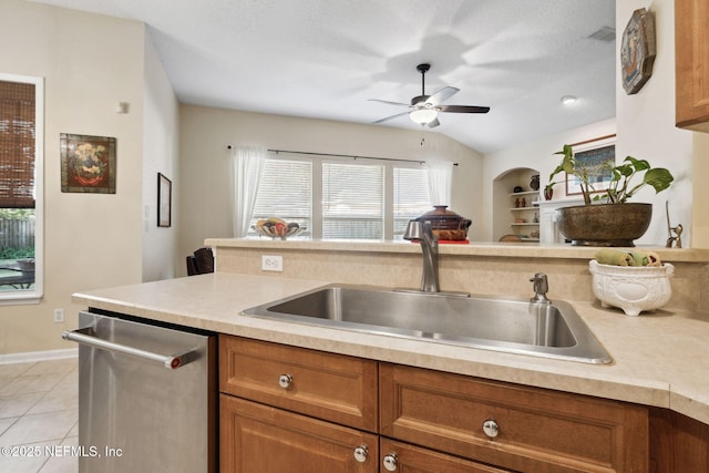 kitchen with a textured ceiling, ceiling fan, sink, light tile patterned floors, and dishwasher