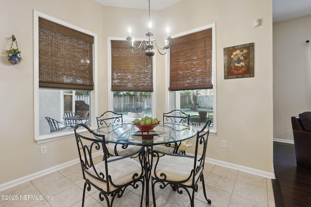 dining space featuring a notable chandelier and light tile patterned flooring