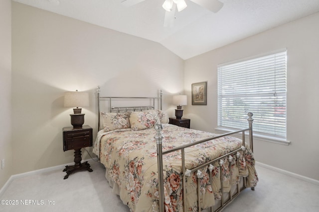 bedroom with ceiling fan, light carpet, and vaulted ceiling