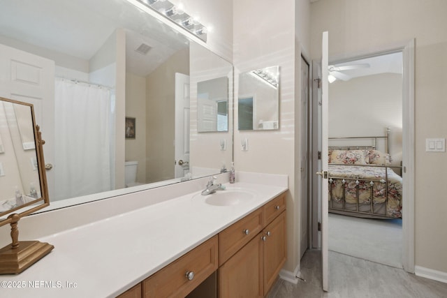 bathroom featuring vanity, ceiling fan, and toilet