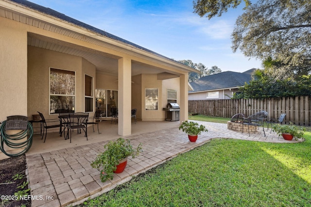 view of yard featuring an outdoor fire pit and a patio area