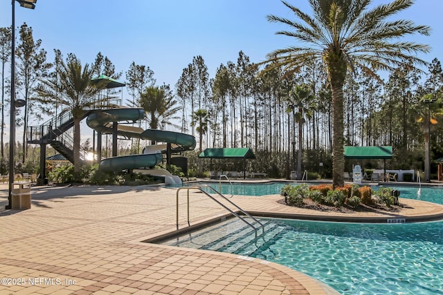 view of swimming pool featuring a patio area and a water slide