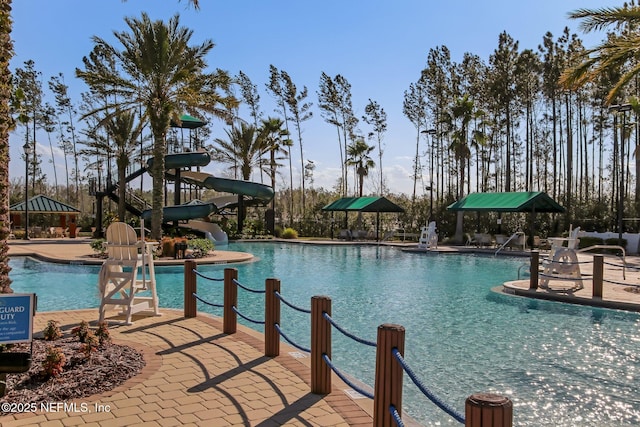 view of pool featuring a patio area and a water slide