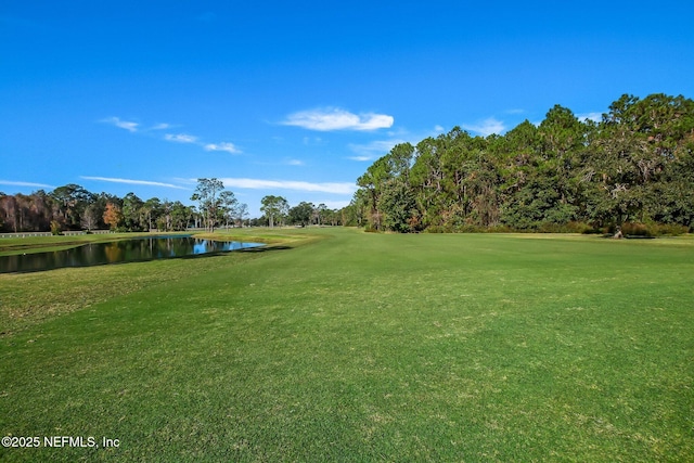 view of home's community featuring a lawn and a water view