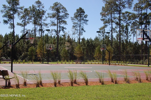 view of basketball court with a yard