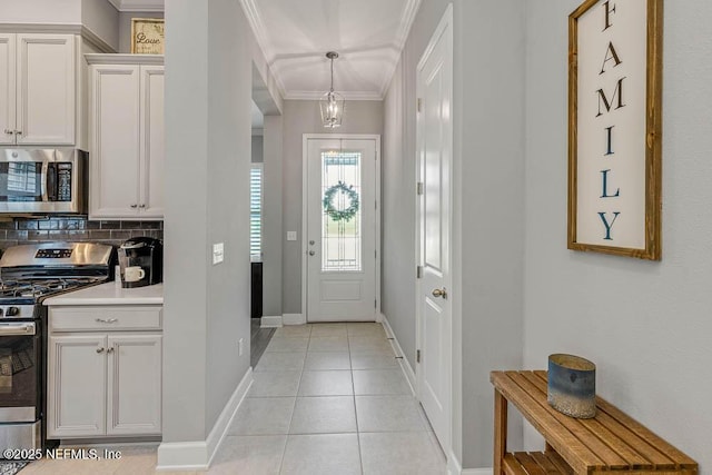 tiled entrance foyer featuring ornamental molding