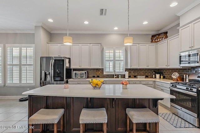 kitchen featuring a kitchen breakfast bar, a center island, and stainless steel appliances