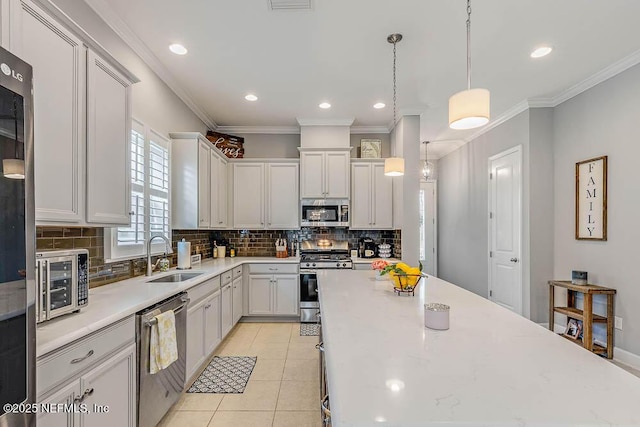 kitchen featuring white cabinetry, sink, decorative light fixtures, light tile patterned flooring, and appliances with stainless steel finishes