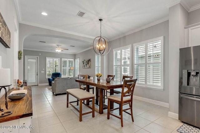 tiled dining area featuring ceiling fan with notable chandelier and ornamental molding