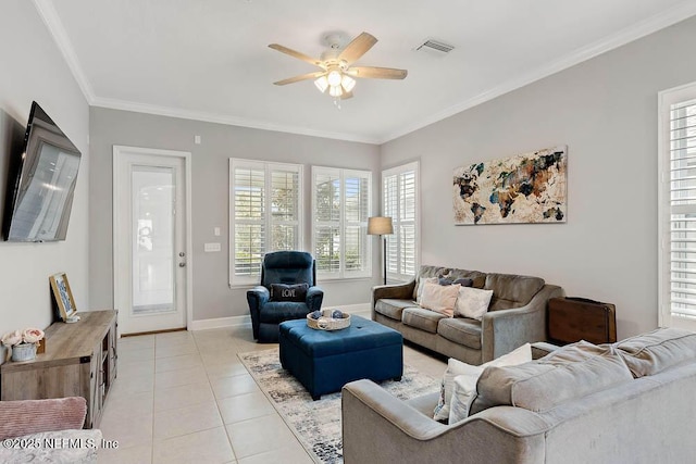 living room with ceiling fan, light tile patterned flooring, and ornamental molding