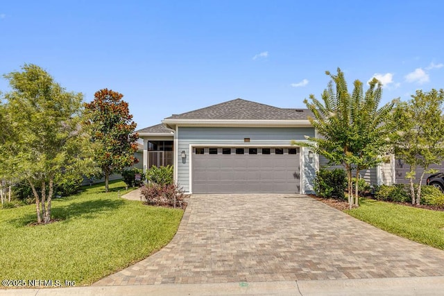 view of front of property featuring a garage and a front lawn