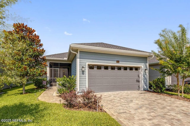 view of front of house with a garage and a front lawn