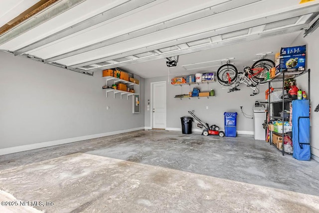 garage with electric panel and a garage door opener