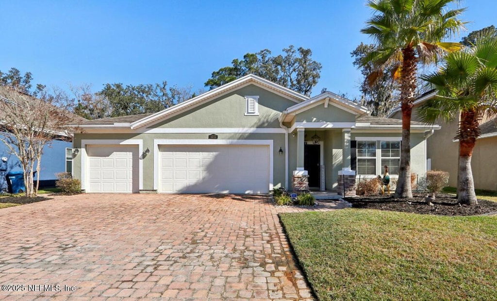 ranch-style house featuring a front yard and a garage