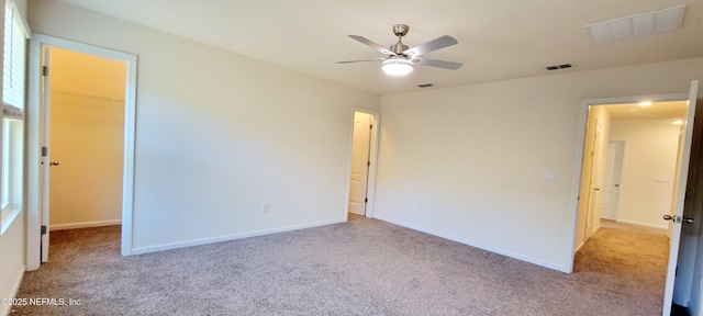 interior space with light carpet, a spacious closet, and a closet