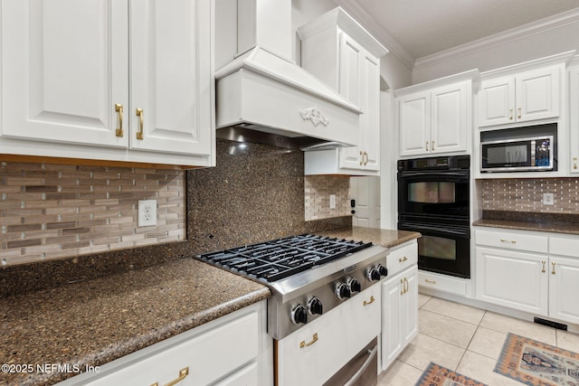 kitchen featuring white cabinets, double oven, premium range hood, and stainless steel gas cooktop