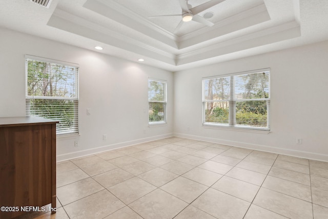 tiled empty room featuring a raised ceiling, ceiling fan, and crown molding