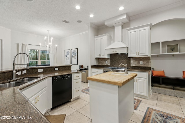 kitchen featuring wooden counters, black dishwasher, white cabinetry, and sink