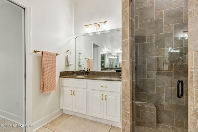 bathroom featuring tile patterned flooring, vanity, and a shower with shower door