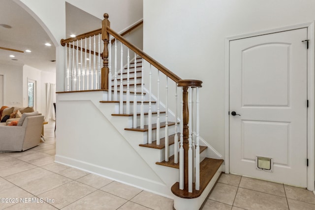 staircase with tile patterned floors