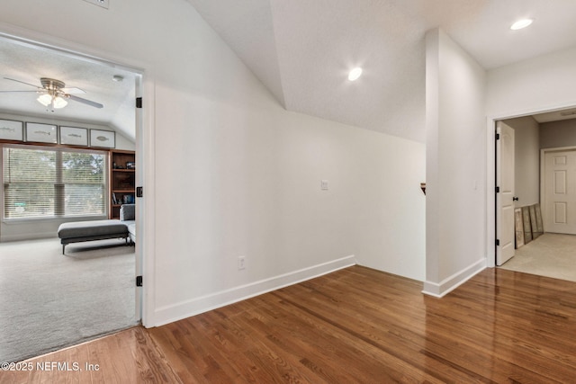 interior space with ceiling fan, wood-type flooring, and lofted ceiling