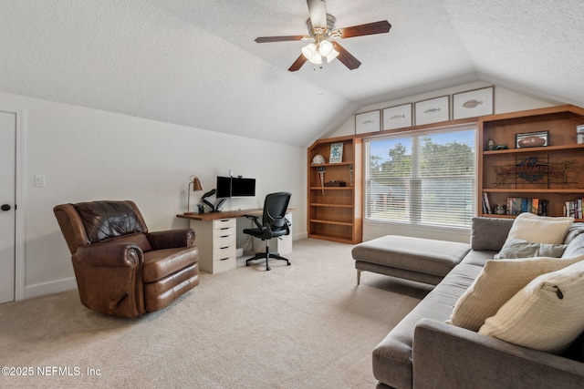 office area featuring a textured ceiling, ceiling fan, light carpet, and lofted ceiling