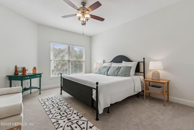 carpeted bedroom with ceiling fan and a textured ceiling