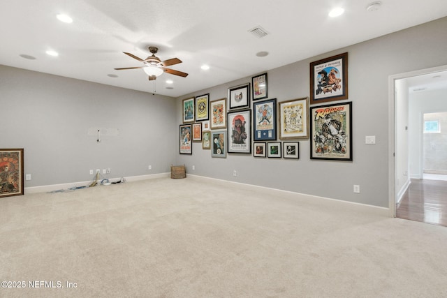 carpeted spare room featuring ceiling fan