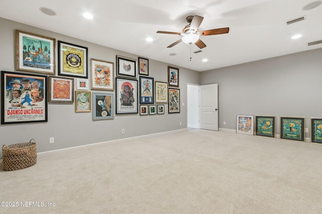 interior space with ceiling fan and light colored carpet