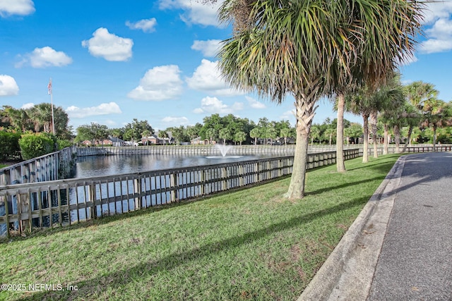 dock area featuring a yard and a water view