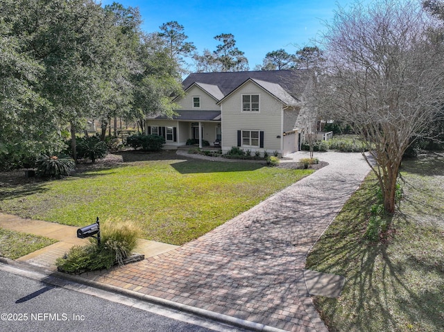 front facade featuring a garage and a front yard