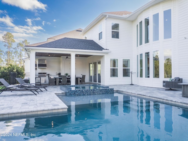 view of swimming pool with a patio, ceiling fan, and an in ground hot tub