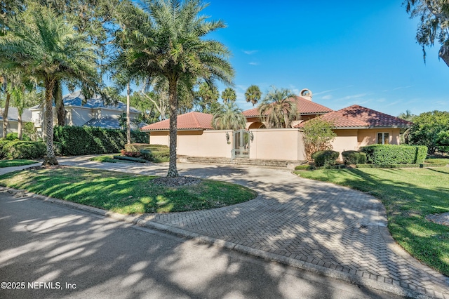 mediterranean / spanish-style house with a front yard