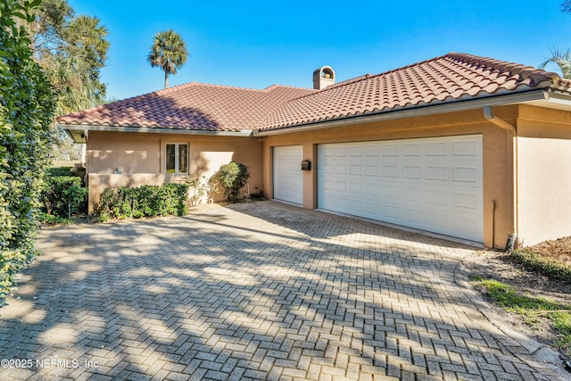 mediterranean / spanish house featuring a garage