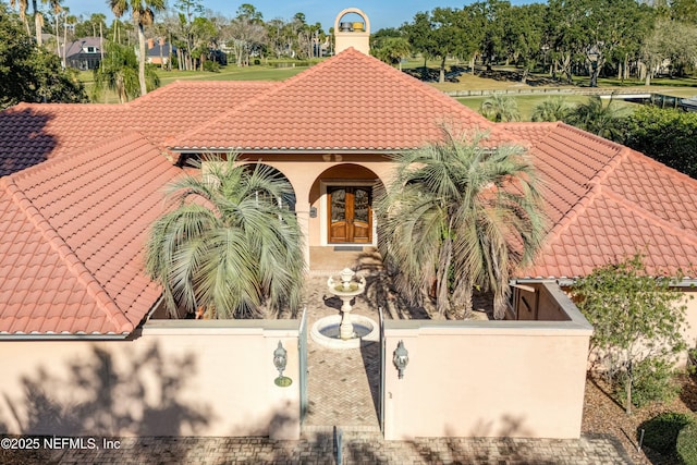 mediterranean / spanish-style home with french doors