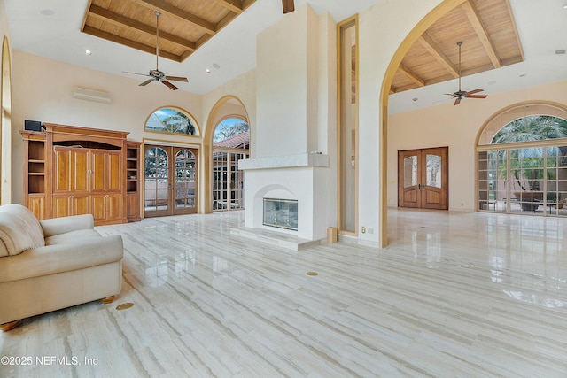 unfurnished living room featuring beam ceiling, wood ceiling, and a high ceiling