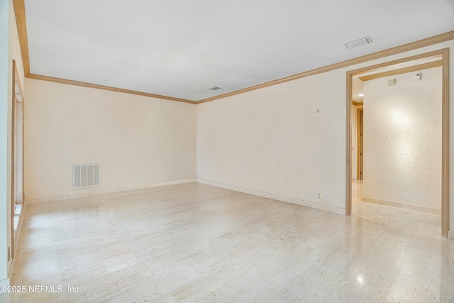 empty room featuring crown molding