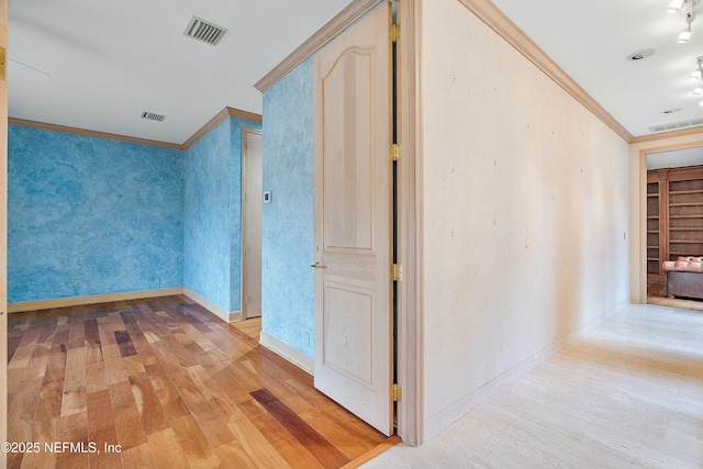 corridor featuring light hardwood / wood-style flooring and crown molding