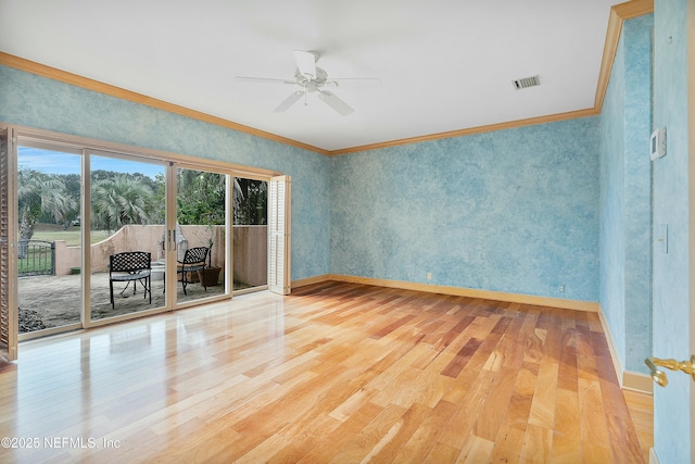 empty room featuring hardwood / wood-style floors, ceiling fan, and crown molding