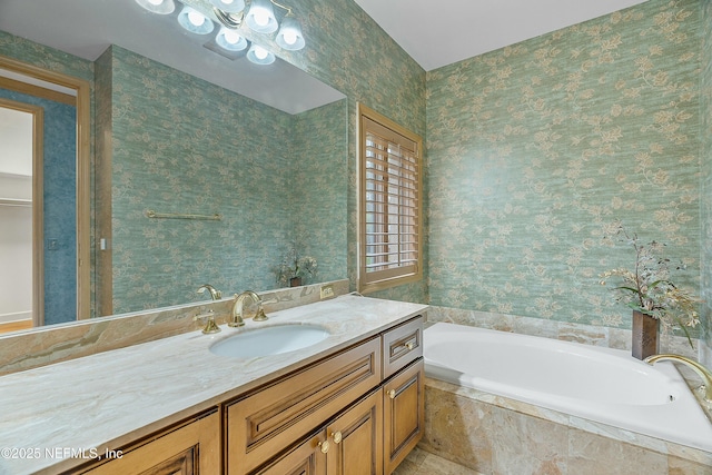 bathroom featuring tiled bath and vanity