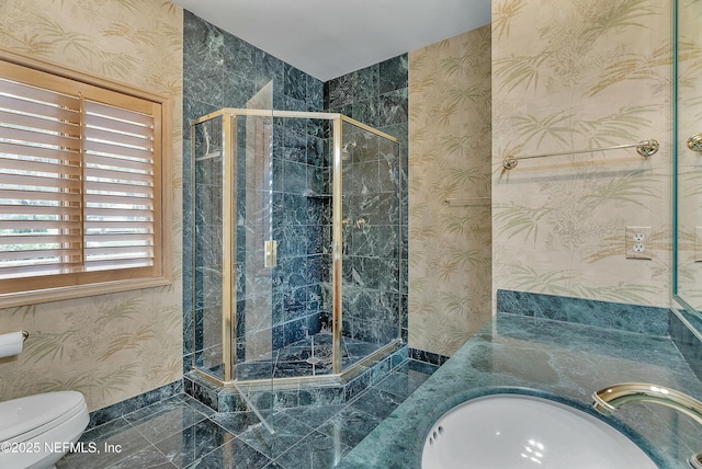 bathroom featuring a shower with door, vanity, and toilet