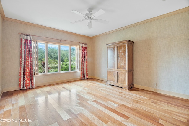 empty room featuring ceiling fan, light hardwood / wood-style flooring, and ornamental molding