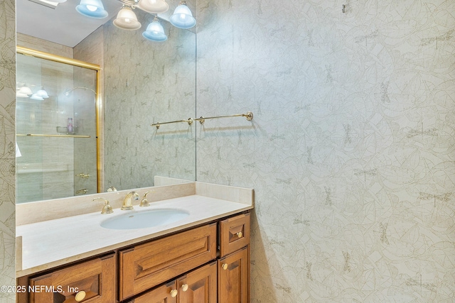 bathroom featuring vanity and an enclosed shower