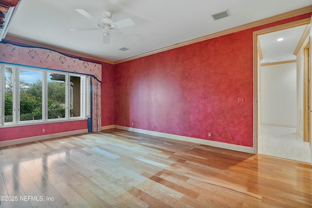 empty room with ceiling fan, light hardwood / wood-style floors, and ornamental molding