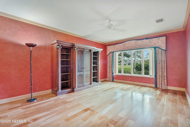 unfurnished room with ceiling fan, light hardwood / wood-style floors, and crown molding