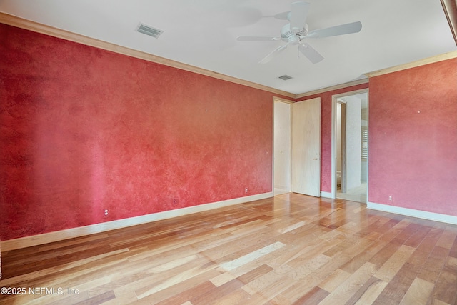 empty room with light hardwood / wood-style floors, ceiling fan, and crown molding