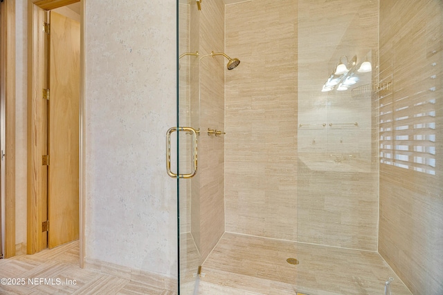 bathroom featuring a shower with shower door