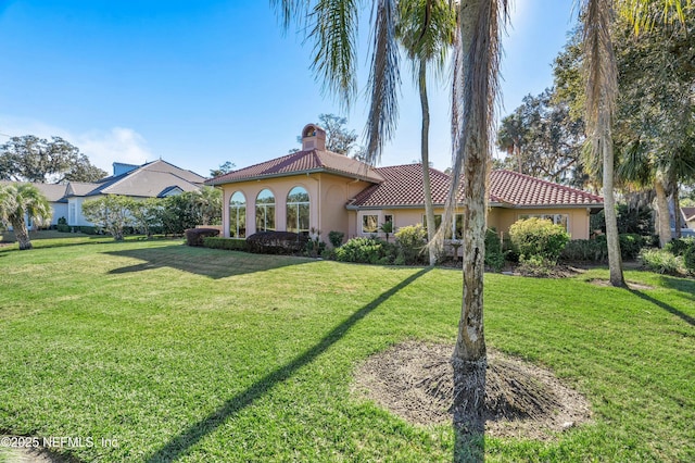 mediterranean / spanish-style home with a front yard