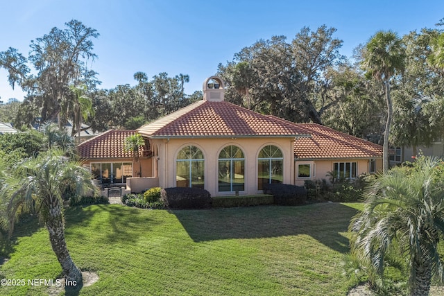 rear view of property with a yard