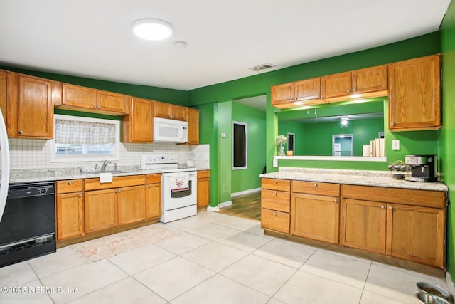 kitchen featuring white appliances, light tile patterned floors, tasteful backsplash, and sink